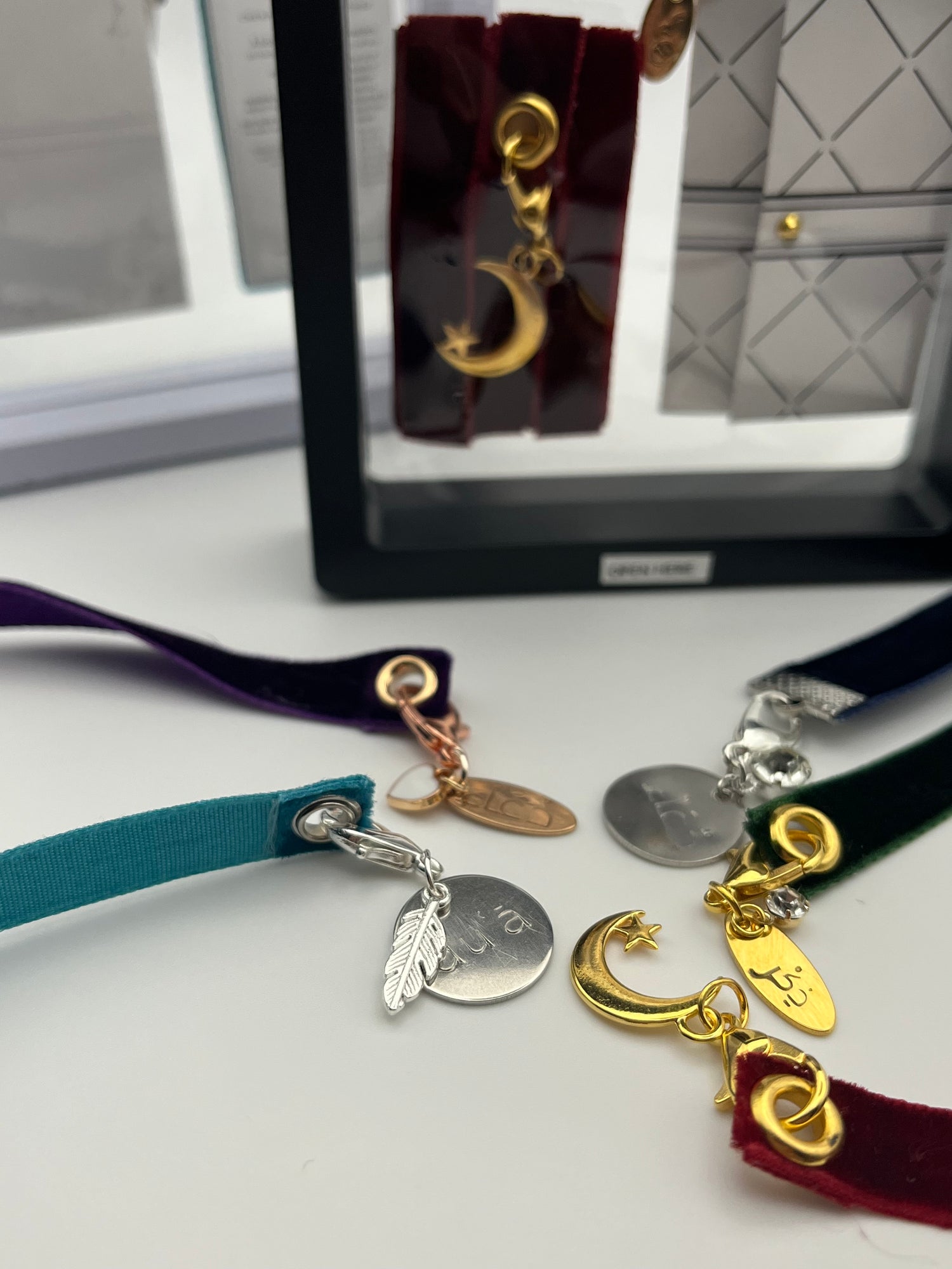 BeLoved Gifts Islamic Inspired velvet Ribbon bookmarks. Hand-stamped charm with a charm, that says Dua in Arabic and English Dhikr in Arabic, or a Star and moon BeLoved Gifts exclusive feature of mini card with a hidden message.