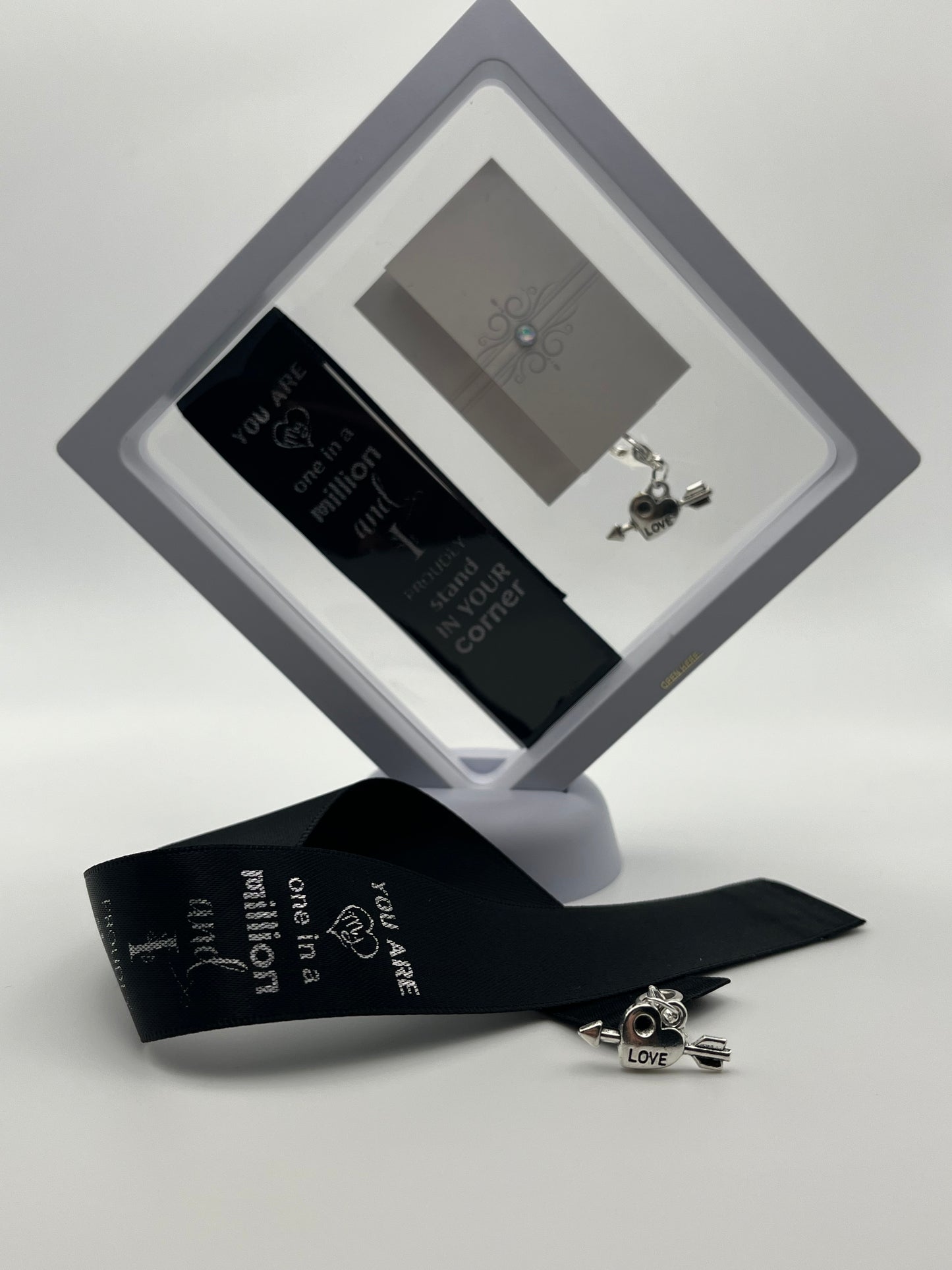 ANNIVERSARY - “You are one in a million and I proudly stand in your corner “- Black Satin Reusable Adhesive Book-It™ Bookmark with a Charm (Heart with Arrow) in Gift Box