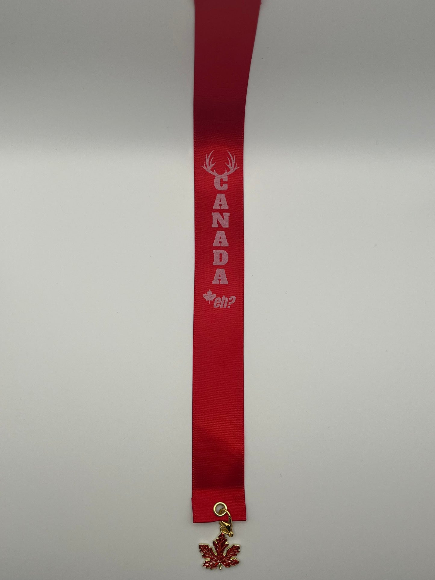 “CANADA, eh?” – Red Satin Reusable Adhesive Bookmark with a Charm (Canadian Maple Leaf) in Gift Box