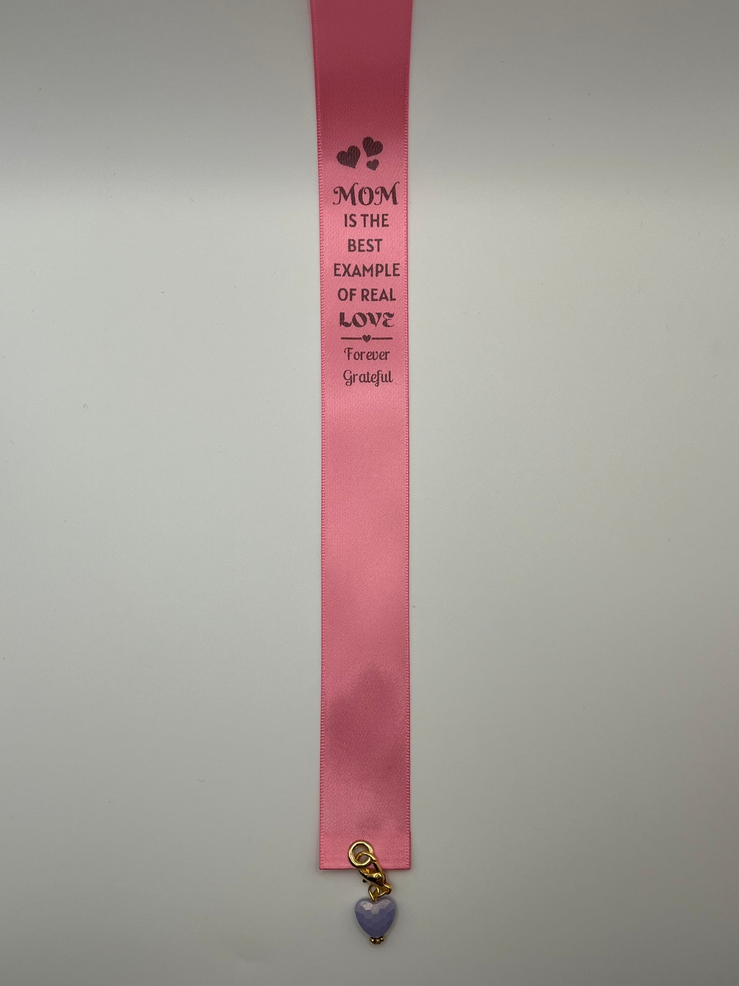 MOTHER’S DAY – “Mom is the best example of real love - forever grateful”- Pink Satin Reusable Adhesive Book-It™ Bookmark with a Charm (Coloured Heart Bead)