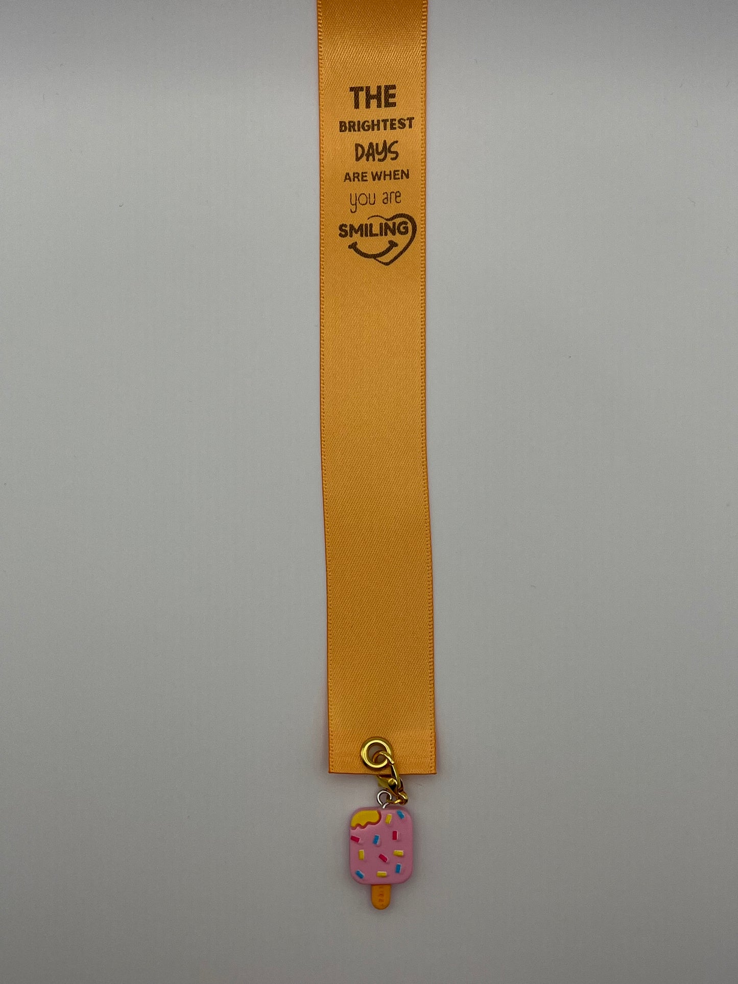 LIFE SMILES – “The brightest days are when you are smiling” - Orange Satin Reusable Adhesive Book-It™ Bookmark with a Charm (Ice Cream Popsicle)