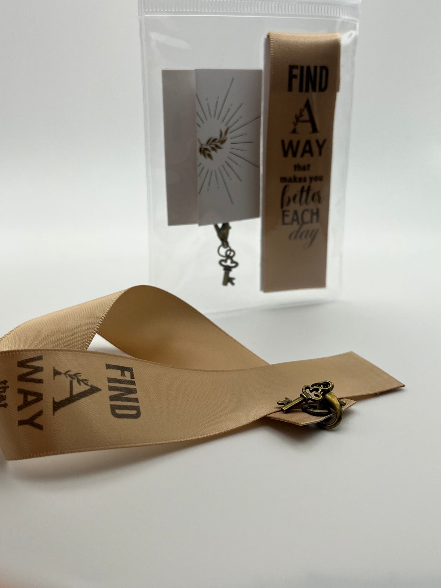 INSPIRATIONAL – “Find a way that makes you better each day” - Beige Satin Reusable Adhesive Book-It™ Bookmark with a Charm (Bronze Key)