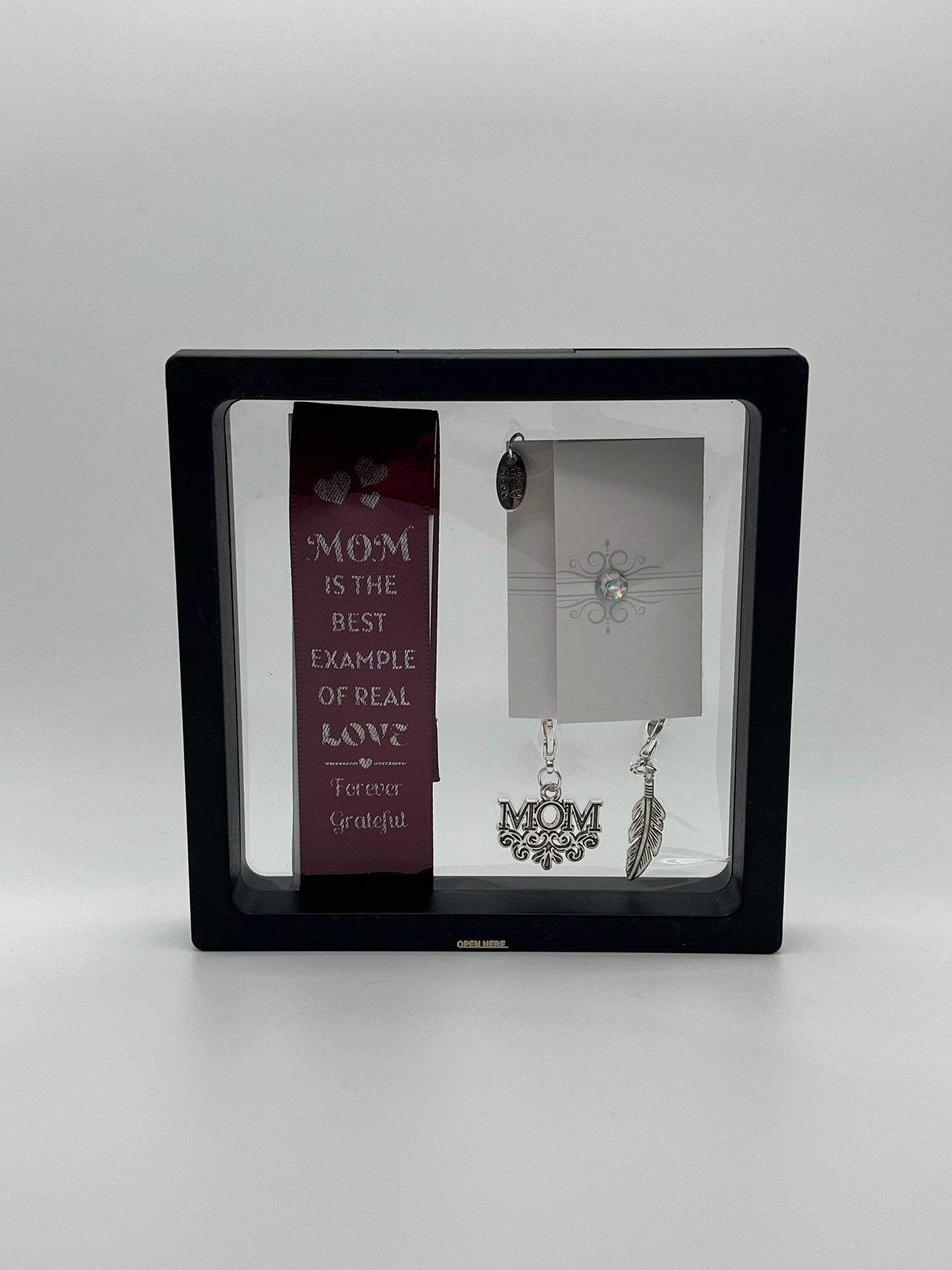 FOR MOM - “Mom is the best example of real love - forever grateful” – Burgundy Satin Reusable Adhesive Book-It™ Bookmark with Two Charms (M-O-M, Feather) in Gift Box + Hidden Scratch Gift Message