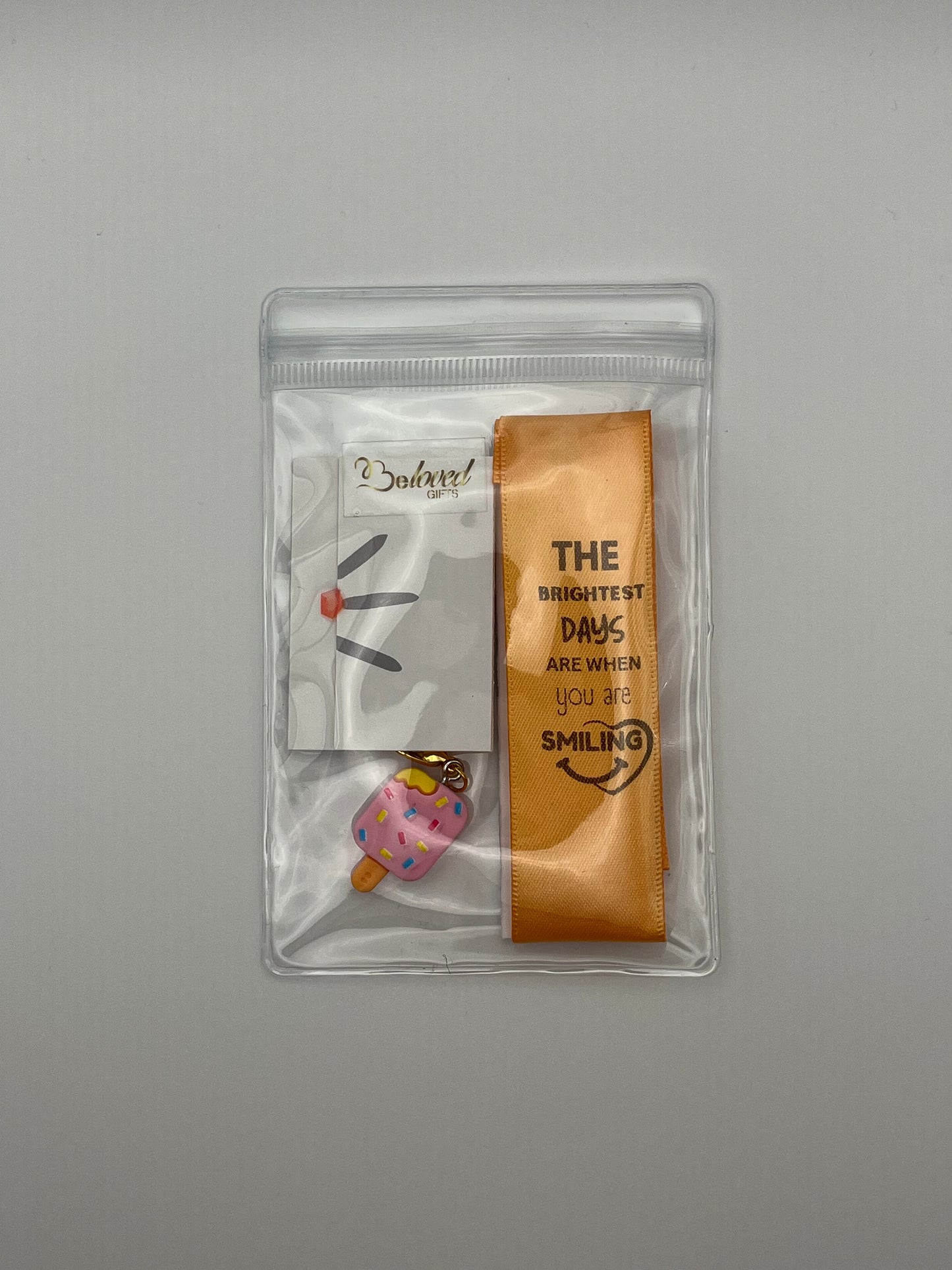 LIFE SMILES – “The brightest days are when you are smiling” - Orange Satin Reusable Adhesive Book-It™ Bookmark with a Charm (Ice Cream Popsicle)