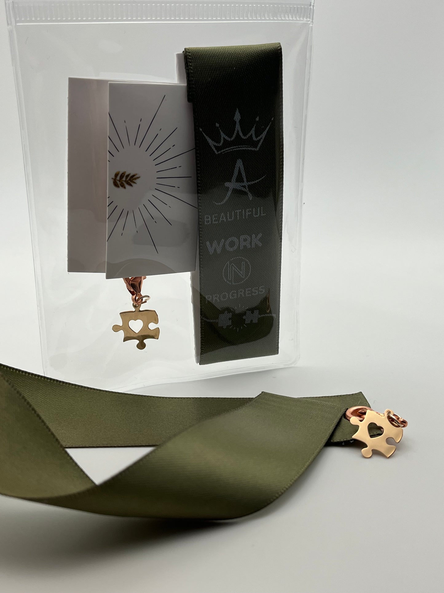 MOTIVATIONAL – “A beautiful work in progress” - Olive Green or Black Satin Reusable Adhesive Book-It™ Bookmark with a Charm (Puzzle Piece)