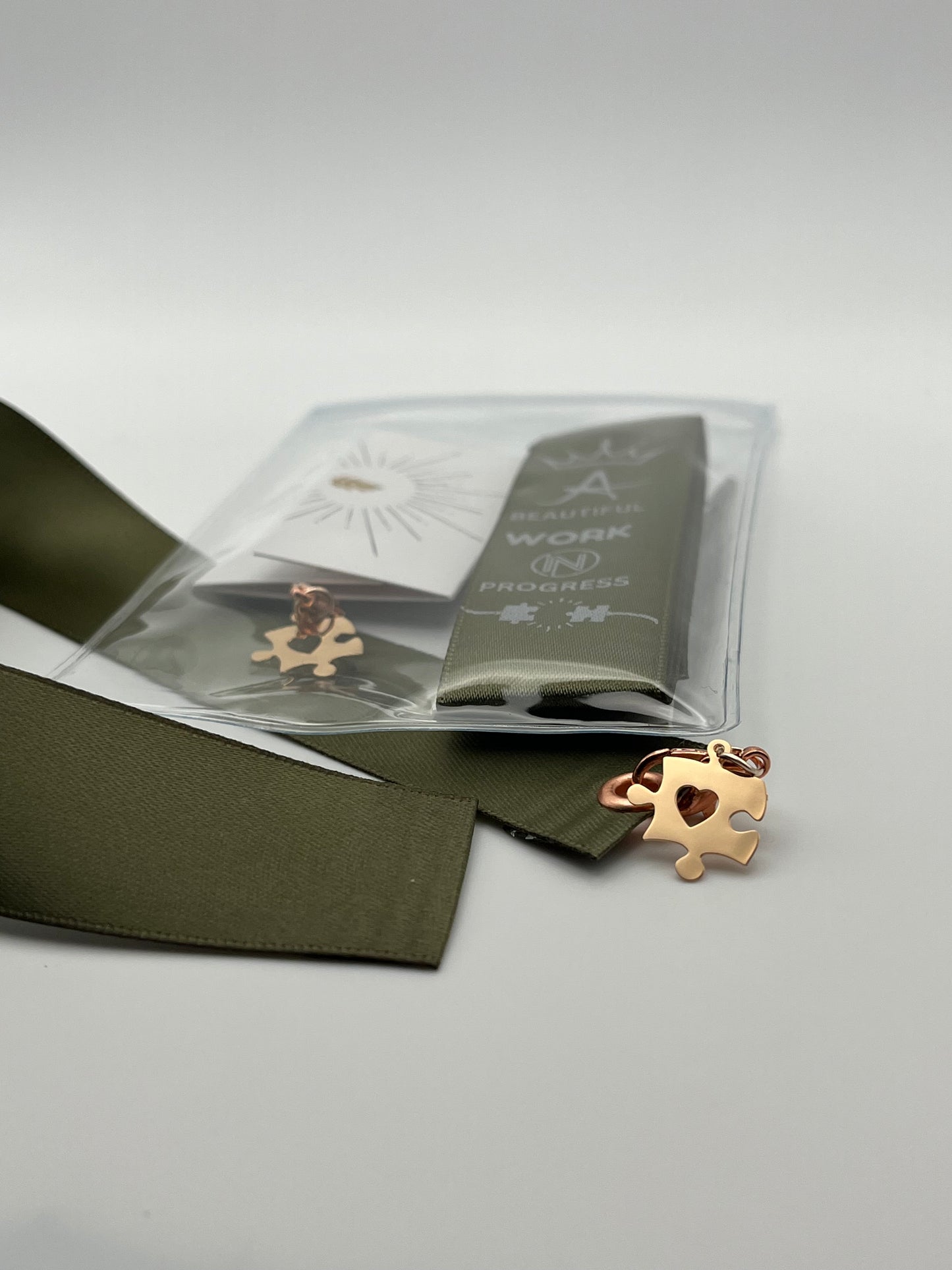 MOTIVATIONAL – “A beautiful work in progress” - Olive Green or Black Satin Reusable Adhesive Book-It™ Bookmark with a Charm (Puzzle Piece)