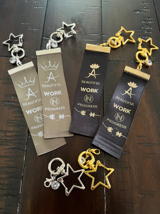 A Beautiful Work in Progress – Inspirational Keychain Gift - – Black Ribbon with Gold Text -  Gold Swivel Star Keyring and Gem