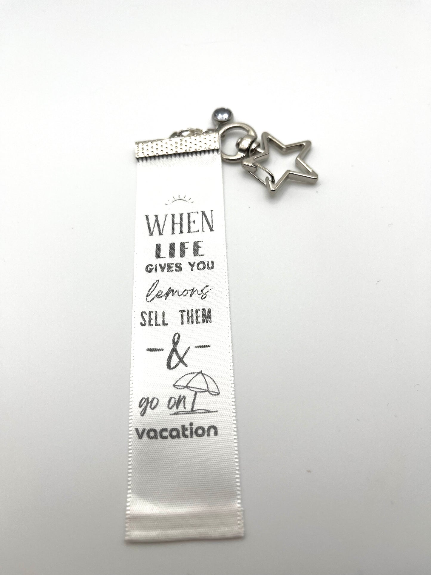 When Life Gives You Lemons, Sell Them and Go On Vacation  - Inspirational Keychain Gift -  Sell – White Ribbon with Grey Text